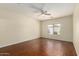 Spacious bedroom features a ceiling fan, window with blinds, and wood-look floors at 16848 W Rimrock St, Surprise, AZ 85388