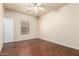Well-lit bedroom with a ceiling fan, a window, and wood-look floors at 16848 W Rimrock St, Surprise, AZ 85388