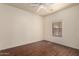 Cozy bedroom with ceiling fan, window for natural light, and wood-look flooring at 16848 W Rimrock St, Surprise, AZ 85388