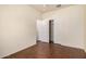 Bedroom featuring wood floors, closet with sliding doors, and access to the hallway at 16848 W Rimrock St, Surprise, AZ 85388