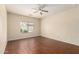 Bright bedroom with a ceiling fan, window with blinds, and hardwood flooring at 16848 W Rimrock St, Surprise, AZ 85388