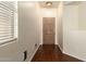 Inviting entryway with hardwood floors, neutral walls, and a solid wood door at 16848 W Rimrock St, Surprise, AZ 85388