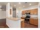 Bright kitchen with breakfast bar, stainless steel appliances, and wood cabinetry at 16848 W Rimrock St, Surprise, AZ 85388