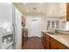 Well-lit kitchen featuring wood cabinets, stainless steel appliances, and a view into the dining area at 16848 W Rimrock St, Surprise, AZ 85388
