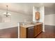 Kitchen with stainless steel dishwasher and sink, countertop, and opens to a living area at 16848 W Rimrock St, Surprise, AZ 85388