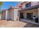 The backyard features a covered patio, rock landscaping and a neutral color palette at 1718 S Longmore -- # 95, Mesa, AZ 85202