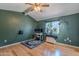 Spacious bedroom featuring a functional workspace complemented by a ceiling fan and hardwood flooring at 1718 S Longmore -- # 95, Mesa, AZ 85202