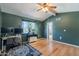 Spacious bedroom featuring a functional workspace complemented by a ceiling fan and hardwood flooring at 1718 S Longmore -- # 95, Mesa, AZ 85202
