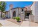 Charming townhouse with desert landscaping, an arched window, and a private gated front entry at 1718 S Longmore -- # 95, Mesa, AZ 85202