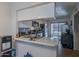 Functional kitchen with stainless steel appliances, ample counter space, and a sliding glass door to the patio at 1718 S Longmore -- # 95, Mesa, AZ 85202
