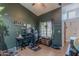 Home office with dark green walls, large window, and ceiling fan at 1718 S Longmore -- # 95, Mesa, AZ 85202