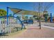 This community playground features shade structures, playground equipment, and open green spaces at 1718 S Longmore -- # 95, Mesa, AZ 85202
