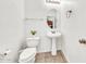 Half bathroom with clean fixtures, white walls, and a tile floor at 1718 W Colter St # 195, Phoenix, AZ 85015
