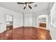 Bright bedroom with hardwood floors, ceiling fan, and an archway leading to the Primary bathroom at 1718 W Colter St # 195, Phoenix, AZ 85015
