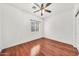 Cozy bedroom featuring hardwood floors, white walls, a window with blinds, and a ceiling fan at 1718 W Colter St # 195, Phoenix, AZ 85015