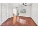 Bright bedroom with hard wood floors, a ceiling fan, a window with blinds, and a door to an outside patio at 1718 W Colter St # 195, Phoenix, AZ 85015