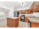 Modern kitchen with granite counters, stainless steel appliances, and an island for food prep at 1718 W Colter St # 195, Phoenix, AZ 85015