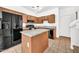 Well-lit kitchen featuring granite countertops, stainless steel appliances, and a functional center island at 1718 W Colter St # 195, Phoenix, AZ 85015
