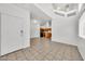 Open-concept living space with tiled floors, kitchen view, and a welcoming front entrance at 1718 W Colter St # 195, Phoenix, AZ 85015