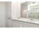 Bright bathroom with double sinks, a large mirror, and a glass-enclosed shower at 17836 W Mission Ln, Waddell, AZ 85355