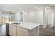 Open-concept kitchen showcasing an island with seating, stainless dishwasher, and easy access to the backyard at 17836 W Mission Ln, Waddell, AZ 85355
