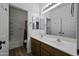 Bathroom with double sink vanity, mirrors, and shower-tub combo at 20200 N Donithan Way, Maricopa, AZ 85138