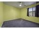 Bedroom with carpeting and a ceiling fan, with a view of the yard at 20200 N Donithan Way, Maricopa, AZ 85138