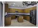 Spacious kitchen features granite countertops, stainless steel appliances, ample wood cabinets and a center island at 20200 N Donithan Way, Maricopa, AZ 85138