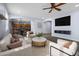 Open-concept living room boasts stylish furnishings, wood floors, a ceiling fan and seamless flow to the kitchen at 20200 N Donithan Way, Maricopa, AZ 85138