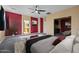 Serene main bedroom with a ceiling fan, carpet floors and ensuite bathroom at 20200 N Donithan Way, Maricopa, AZ 85138