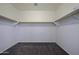 Empty walk-in closet with shelves and space to keep clothes, shoes and other personal items at 20200 N Donithan Way, Maricopa, AZ 85138