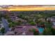 Sunset aerial view of a single-Gathering home in Sonoran Foothills with a private pool and lush landscaping at 2038 W Whisper Rock Trl, Phoenix, AZ 85085