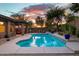 Beautiful sunset view over the backyard pool and patio area at 2038 W Whisper Rock Trl, Phoenix, AZ 85085
