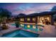 Backyard pool at dusk with blue lighting and patio at 2038 W Whisper Rock Trl, Phoenix, AZ 85085