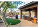 Backyard view showcasing a pool, patio, outdoor furniture, BBQ, and artificial grass at 2038 W Whisper Rock Trl, Phoenix, AZ 85085