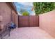 View of the backyard featuring a gravel area with a fence and access to utilities at 2038 W Whisper Rock Trl, Phoenix, AZ 85085