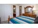 Bedroom showcasing a decorative wood dresser with mirror, and direct access to the en-suite bathroom at 2038 W Whisper Rock Trl, Phoenix, AZ 85085