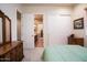 Bright bedroom showcasing a wooden dresser and providing access to an en-suite bathroom at 2038 W Whisper Rock Trl, Phoenix, AZ 85085