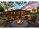Cozy fire pit area with seating and putting green in the backyard at 2038 W Whisper Rock Trl, Phoenix, AZ 85085