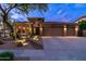 Charming home exterior with desert landscaping, three-car garage, and appealing architectural features at 2038 W Whisper Rock Trl, Phoenix, AZ 85085