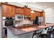Stylish kitchen equipped with stainless steel appliances, ample counter space, and breakfast bar seating at 2038 W Whisper Rock Trl, Phoenix, AZ 85085