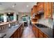 Well-appointed kitchen featuring stainless steel appliances, breakfast bar, and views of the outdoor dining area at 2038 W Whisper Rock Trl, Phoenix, AZ 85085