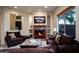 Inviting living room featuring a marble fireplace, comfortable seating, and natural light at 2038 W Whisper Rock Trl, Phoenix, AZ 85085