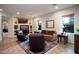 Comfortable living area with stylish decor, a fireplace, and abundant natural light from large windows at 2038 W Whisper Rock Trl, Phoenix, AZ 85085