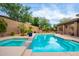 Pool and spa with stone trim and mature landscaping at 2038 W Whisper Rock Trl, Phoenix, AZ 85085