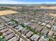 Expansive aerial view of a residential community featuring single-Gathering homes, some with private pools, under a clear blue sky at 22728 E Camacho Rd, Queen Creek, AZ 85142