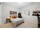 Cozy bedroom features neutral tones, carpet flooring, and a bright window with shutters at 22728 E Camacho Rd, Queen Creek, AZ 85142