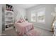 Delightful bedroom with a pink bed, canopy, and ample natural light through shuttered windows at 22728 E Camacho Rd, Queen Creek, AZ 85142