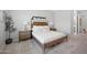 Stylishly decorated bedroom features a wooden bed frame and matching bedside tables at 22728 E Camacho Rd, Queen Creek, AZ 85142
