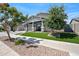 Inviting single-story home featuring a covered porch, lush landscaping, and a welcoming walkway at 22728 E Camacho Rd, Queen Creek, AZ 85142